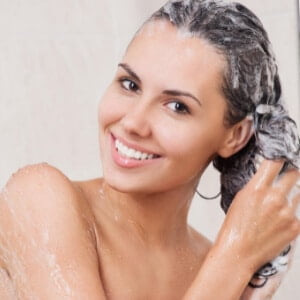 Woman Smiling Washing Her Hair